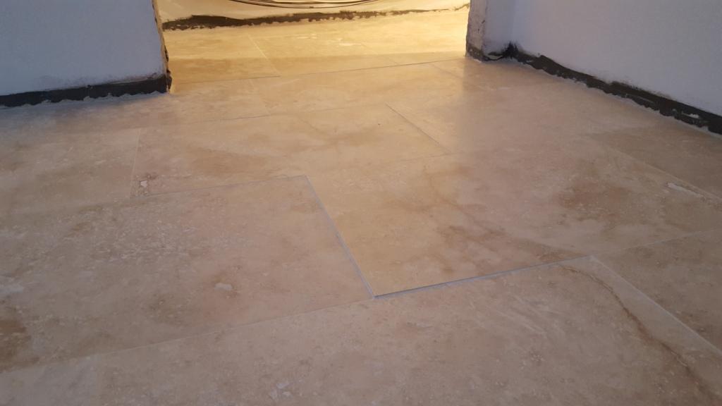 Uneven Travertine Floor Before Levelling and Polishing in Swansea